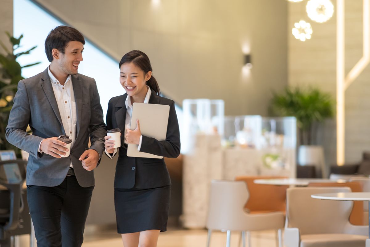 Business professionals walking through a modern lobby in Metro Manila